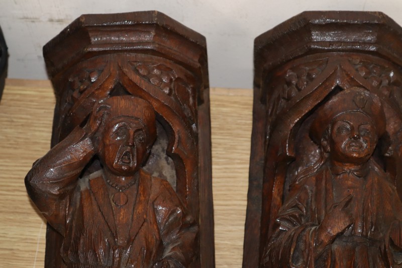 A pair of Italian carved oak figural wall shelves, length 42cm